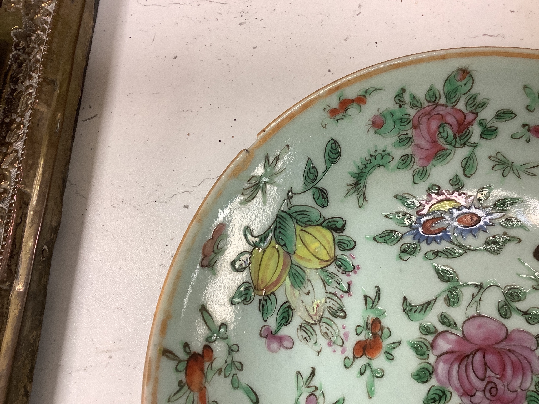 A Chinese famille rose plate and a celadon plate, diameter 24cm